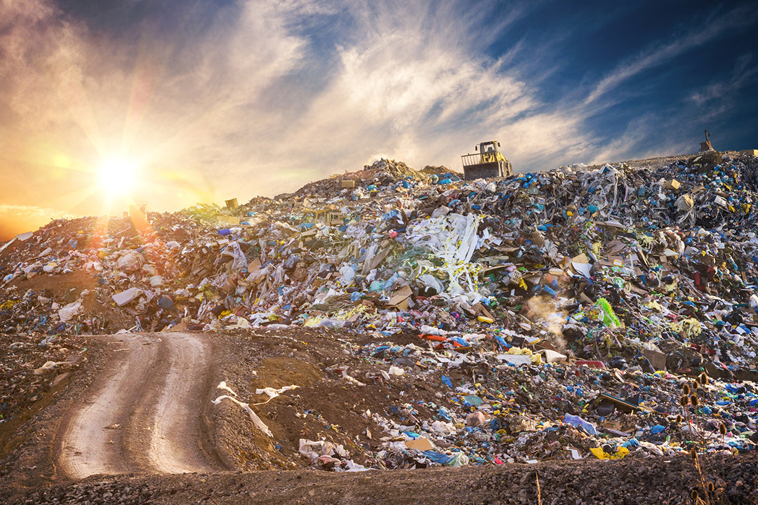 Plastic pollution buried in a mountain of garbage in trash dump or landfill.